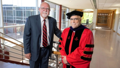 Professor Rich Haber, at left, with Jon Oliver in regalia that originally belonged to Bill Bauer.