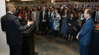 Rutgers University President William F. Tate IV, left, congratulates New Jersey General Assembly Speaker Craig Coughlin.